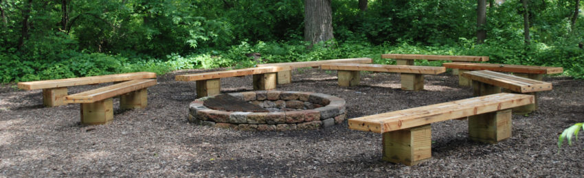 Photo of benches around fire ring in the o