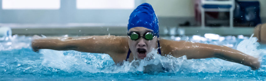 Youth swimming butterfly stroke