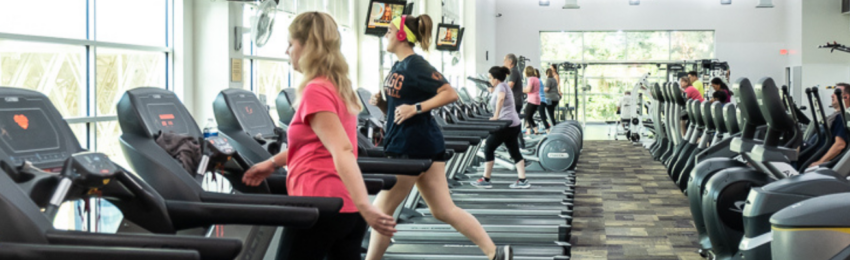 Men and women exercising on treadmills at LIFECENTER Health & Fitness Club.